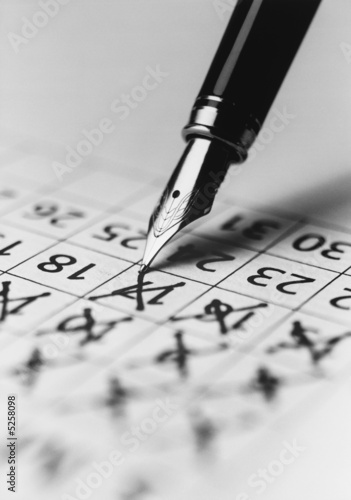 Photo: Pen Marking the Days on a Calendar Pen Marking the Days on a Calendar