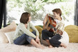 Mother listening to son play guitar