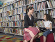 Elementary Student With Teacher in Library