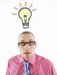 Man in glasses looking up, head and shoulders, below illustrated light bulb