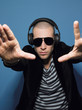 Man wearing headphones in studio view through hands