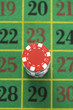 Stack of gambling chips on roulette table, view from above