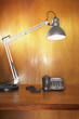Desk Lamp and Phone on Wooden Desk