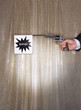 Man firing pistol with bang flag, close-up of hand