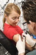 Woman getting tattooed.