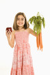Girl holding vegetables.