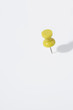 yellow pin on white background