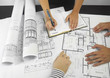 Architects working on blueprints Architects working on blueprints