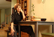 Young, blond girl in a black chemise preparing a meal Young, blond girl in a black chemise preparing a meal