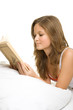 Girl reading book in bed Girl reading book in bed