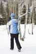Female walking with skis.