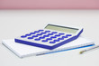 Calculator notebook and pen on table, close up