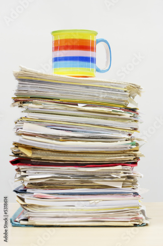 Photo: Coffee Mug on Stack of Files Coffee Mug on Stack of Files