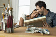 Couple Looking at Painting in Studio