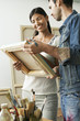 Couple Looking at Painting in Studio