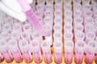 Lab Worker Examining Test Tubes