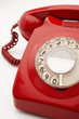 Old fashioned red telephone in studio, cropped