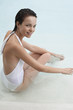 Young woman relaxing in swimming pool, portrait, elevated view