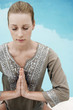 Women in yoga position by swimming pool, elevated view