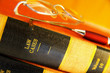 Closeup of law books with glasses and pen