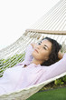 Foto: Female lying in hammock relaxing. Female lying in hammock relaxing.