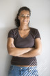 Foto: Portrait of female with arms crossed and smiling. Portrait of female with arms crossed and smiling.