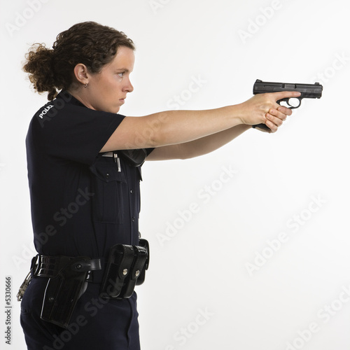 Photo: Policewoman aiming gun. Policewoman aiming gun.