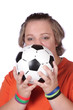 Soccer fan holding football in front of face