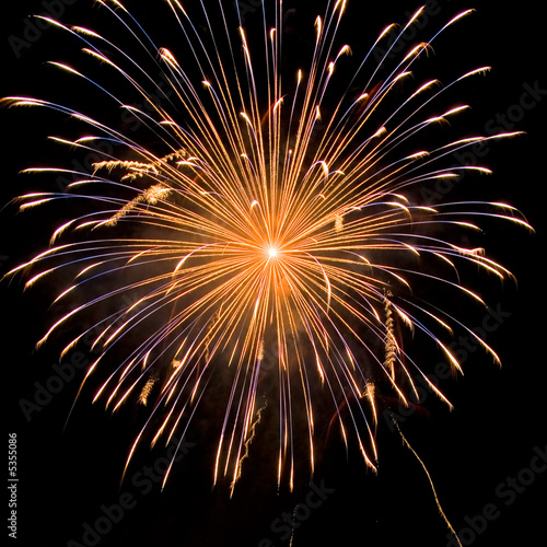 Photo: Yellow and blue fireworks on the black sky Yellow and blue fireworks on the black sky