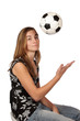 Soccer fan throwing soccer ball into the air