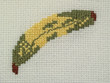 Detail of napkin embroidery (yellow banana), close-up Detail of napkin embroidery (yellow banana), close-up