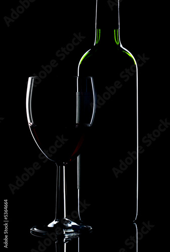 Low key shot of wine bottle and glass