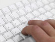 Man working on computer keyboard