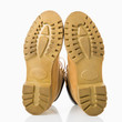 Pair of tan construction boots with sole facing viewer.