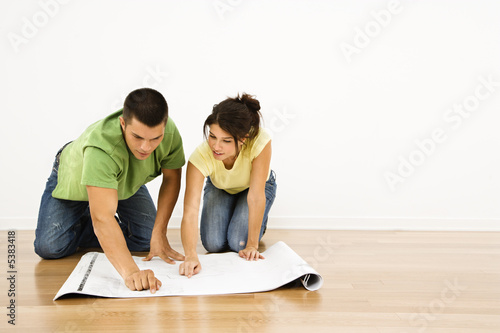 Photo: Couple with house plans. Couple with house plans.