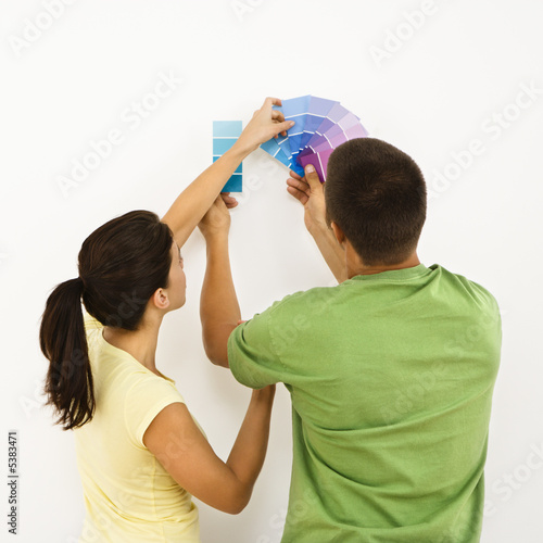 Photo: Couple choosing home color. Couple choosing home color.