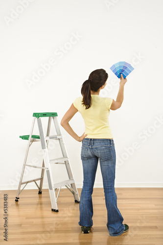 Photo: Woman choosing paint color. Woman choosing paint color.