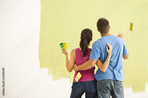 Photo: Couple painting home. Couple painting home.
