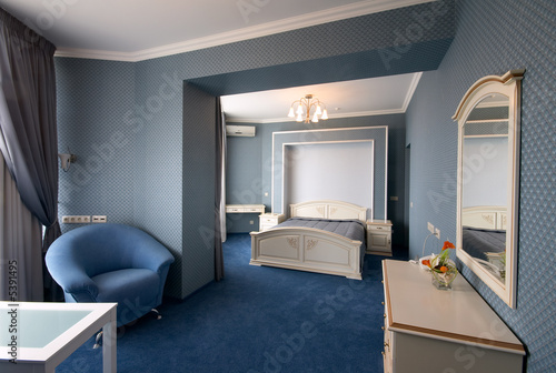 blue bedroom interior with armchair and mirror blue bedroom interior with armchair and mirror