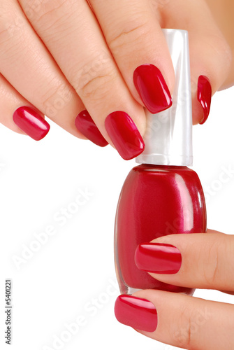 Woman  holding the  bottle of red nail polish.