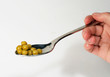 green peas in spoon, on white background