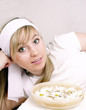 Close up of beautiful woman and bowl with water and daisies