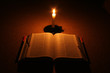 Book in the dark with candle. Book in the dark with candle.