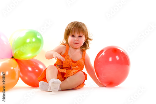 happy girl playing with colorful balloons