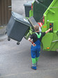 Man operates rubbish collecting machine, close-up Man operates rubbish collecting machine, close-up