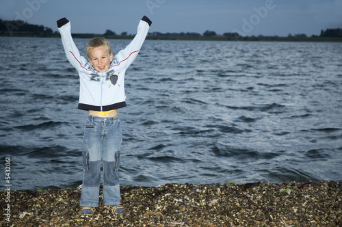 Photo: Boy standing in front of a lake at night. Boy standing in front of a lake at night.