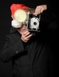 Santa photographer with vintage camera and flash