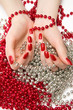 Two woman hands with glassbeads. On white background.