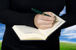 Close-up of a hand starting to write in a blank notebook Close-up of a hand starting to write in a blank notebook