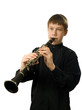 The teenager playing on a clarnet. 